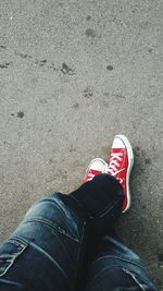 Low section of man standing on road