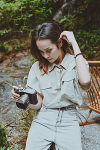 Series photo of young woman photographer with her camera shooting photo outdoor