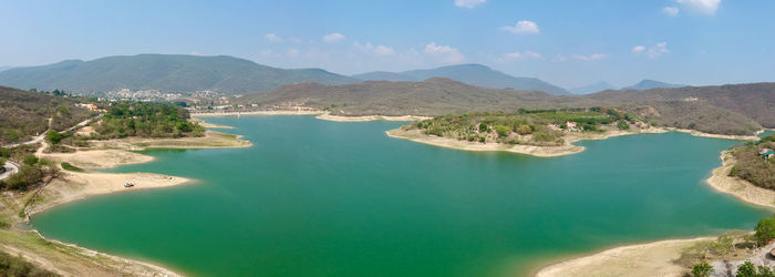 Panoramic view of sea and mountains against sky