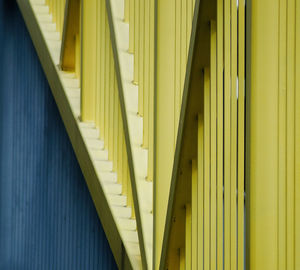 Low angle view of yellow metallic structure on building