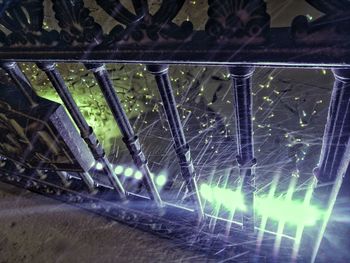 Close-up of illuminated lighting equipment on railing