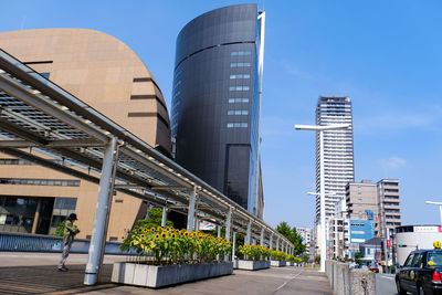 Modern buildings against clear blue sky in city