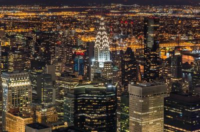 High angle view of city lit up at night