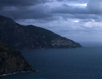 Scenic view of sea and mountains against sky