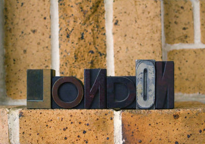 Close-up of london alphabet on brick wall