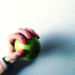 Cropped hand holding over white background