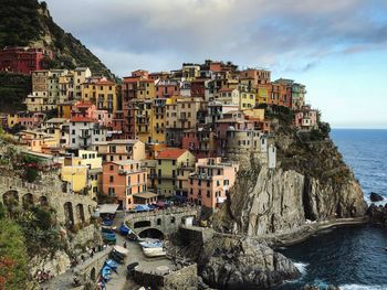 Panoramic view of buildings by sea against sky