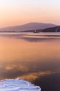 Scenic view of beach against sky during sunset