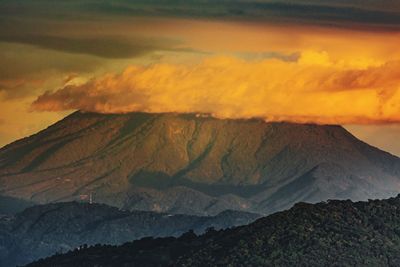 Scenic view of snowcapped mountains against sky during sunset