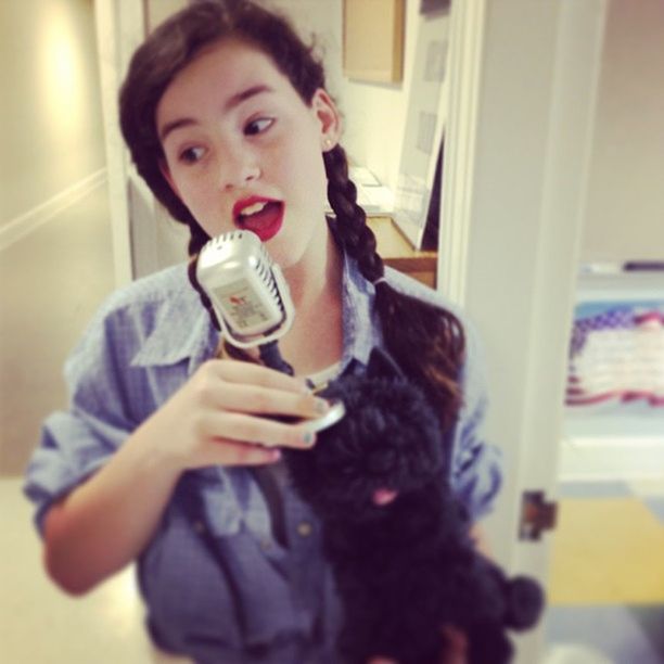 PORTRAIT OF YOUNG WOMAN HOLDING CAMERA IN MIRROR