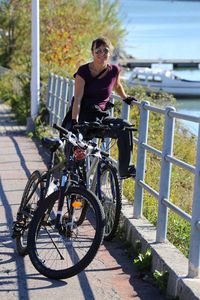 Woman with bicycle on road