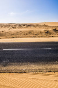 High angle view of road at desert against clear sky