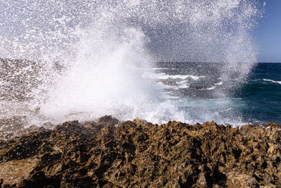 View of waves splashing on rocks