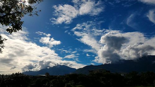 Scenic view of mountains against cloudy sky