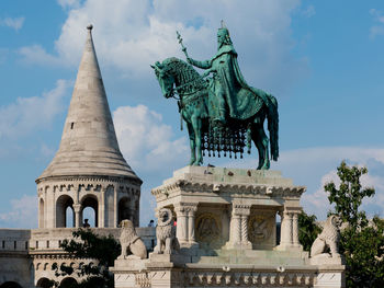 Low angle view of statue against cloudy sky