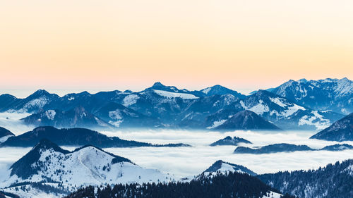 Scenic view of snowcapped mountains against sky during sunset