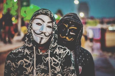 Portrait of man wearing mask standing in city