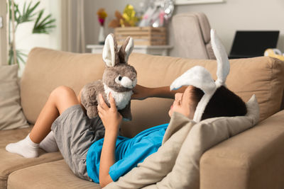 Close-up of rabbit on bed at home