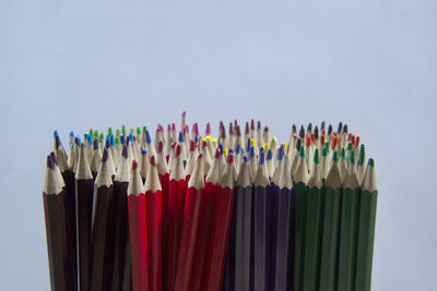 Close-up of multi colored pencils against white background