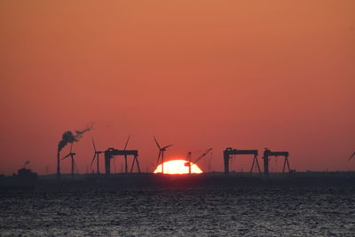 Scenic view of sea against orange sky