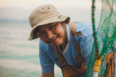 Portrait of man wearing hat standing outdoors