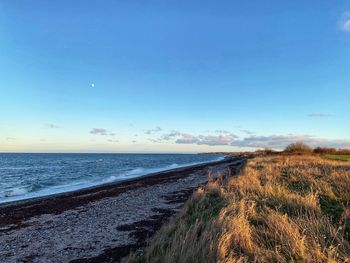 Scenic view of sea against clear blue sky
