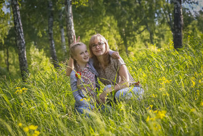 Full length of smiling girl on grassy field