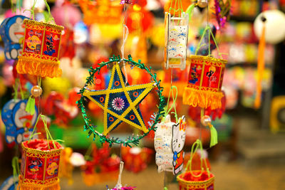 Close-up of decorations hanging in market stall for sale