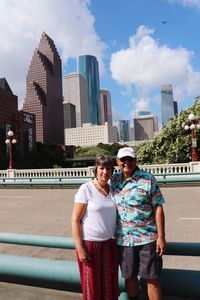 Friends standing by buildings in city against sky