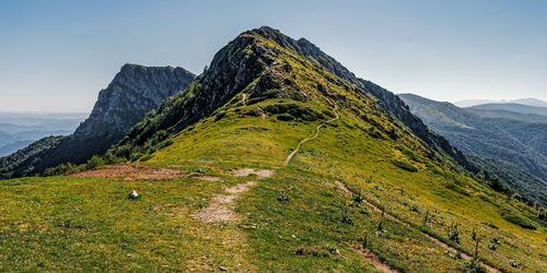 Hinking on an eco trail leading into the mountain ridge.