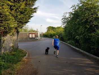 Boy running with a dog