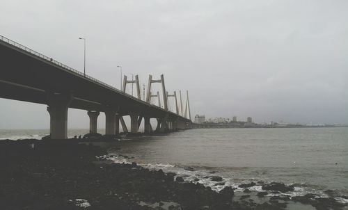 Bridge over pier against sky