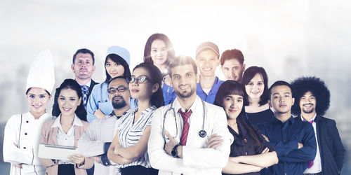 Portrait of young couple standing against the wall
