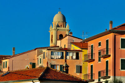 Houses against blue sky in city