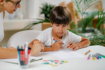 Preschool boy doing school education assessment 