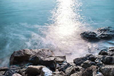 High angle view of waves splashing on rocks