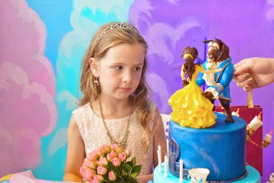 Girl looking at birthday cake