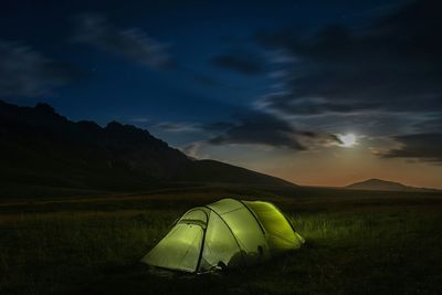 Scenic view of tent under cloudy sky