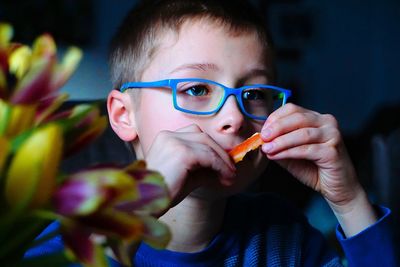 Close-up portrait of young boy eating food