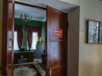 Desk in empty room with open doors