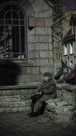 Man sitting in front of building