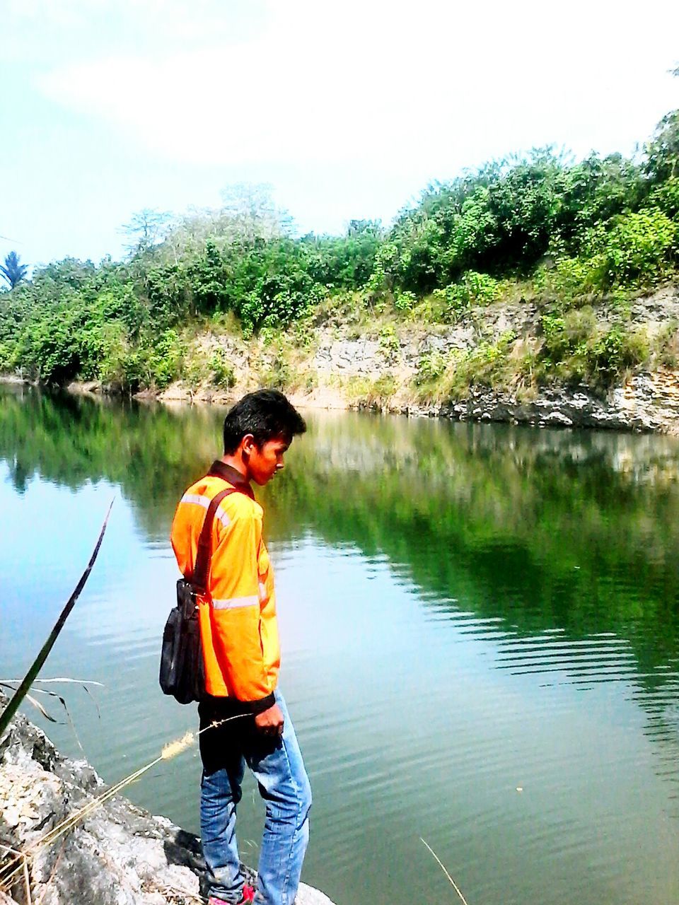 water, lifestyles, tree, lake, leisure activity, casual clothing, standing, three quarter length, rear view, reflection, nature, tranquility, river, full length, men, beauty in nature, tranquil scene, person