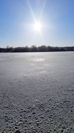 Scenic view of frozen lake against sky during winter