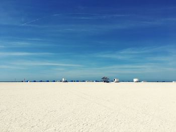 Scenic view of beach against blue sky