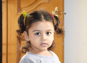 Portrait of cute girl looking away at home