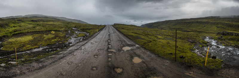 Panoramic view of road leading towards mountains against sky