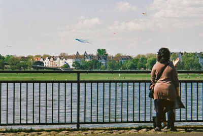 Full length of woman standing against sky