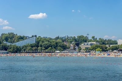 Group of people on beach against sky