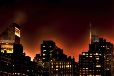 Low angle view of illuminated buildings against sky at dusk