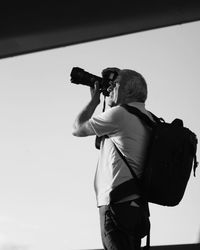 Rear view of man photographing